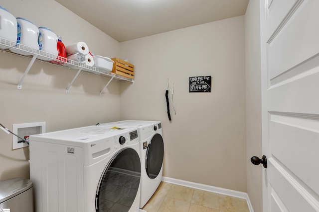 washroom with light tile patterned flooring and washer and dryer