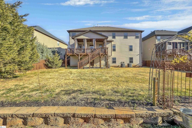 rear view of property with a yard and a deck