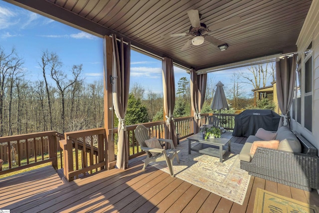 deck featuring grilling area, an outdoor hangout area, and ceiling fan