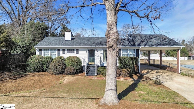 view of front facade with a carport and a front yard