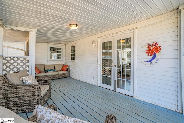 wooden deck with french doors and outdoor lounge area