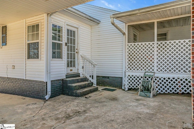 view of exterior entry featuring a patio