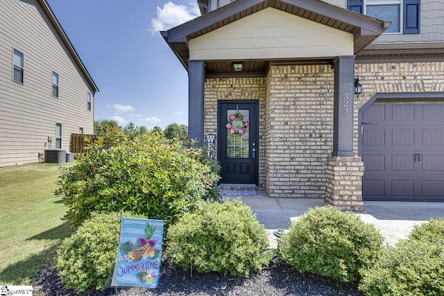 doorway to property featuring central AC and a garage