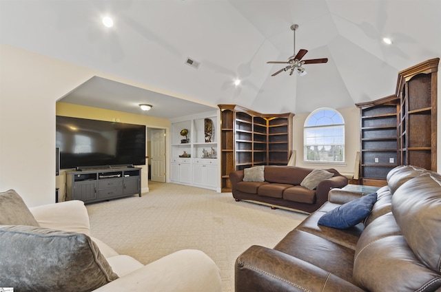 living room with high vaulted ceiling, built in shelves, light colored carpet, and ceiling fan