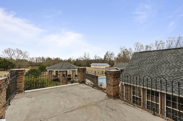 exterior space with a fenced in pool and a patio area