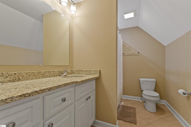 bathroom featuring tile patterned floors, vanity, toilet, and vaulted ceiling