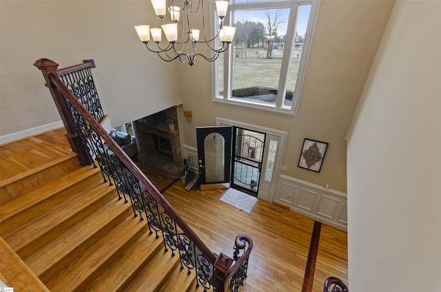 foyer entrance featuring hardwood / wood-style floors and a notable chandelier