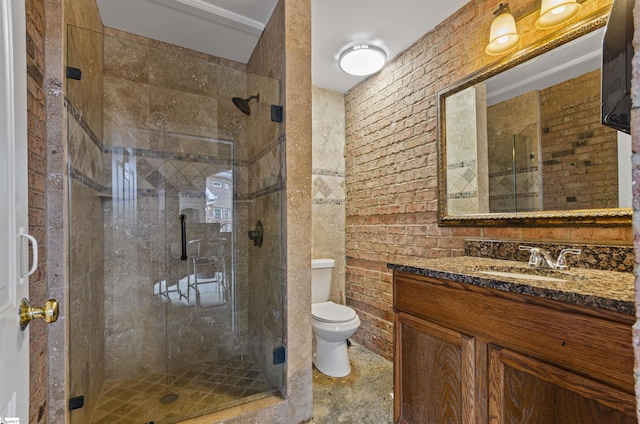 bathroom featuring vanity, a shower with shower door, and toilet