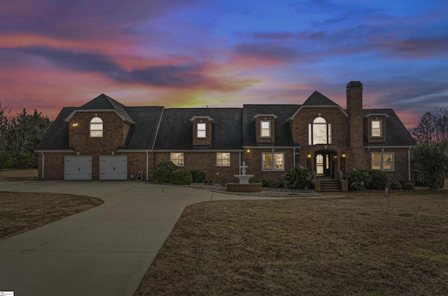 view of front facade featuring a garage and a yard