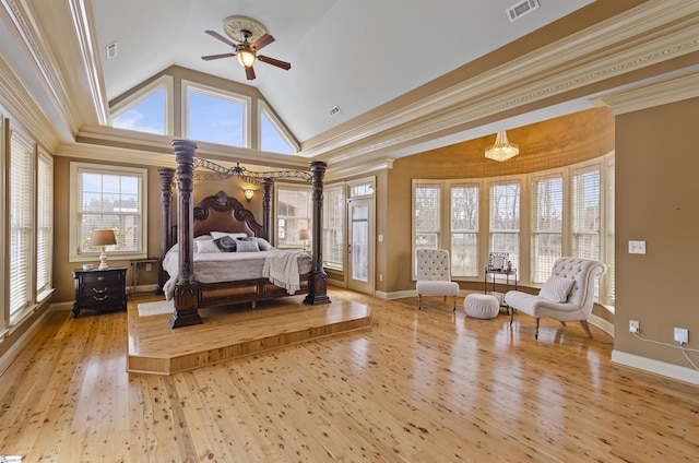 bedroom with crown molding, high vaulted ceiling, and light wood-type flooring