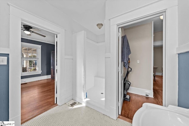 bathroom with ceiling fan and hardwood / wood-style floors