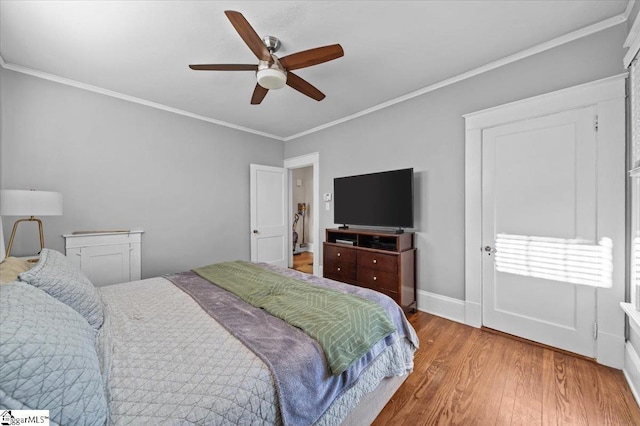 bedroom featuring hardwood / wood-style floors, ornamental molding, and ceiling fan