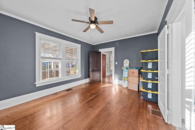 unfurnished bedroom with ceiling fan, ornamental molding, and hardwood / wood-style floors