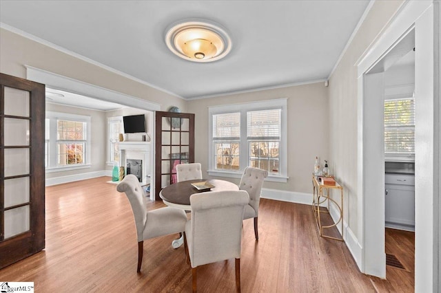 dining room featuring crown molding and light hardwood / wood-style floors