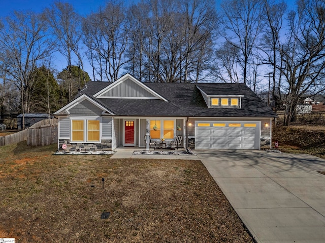 view of front of home with a garage and a front lawn