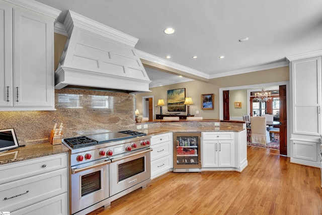 12 Cothran St, Greenville, SC 29605 - kitchen featuring white cabinetry, wine cooler, custom exhaust hood, kitchen peninsula, and range with two ovens