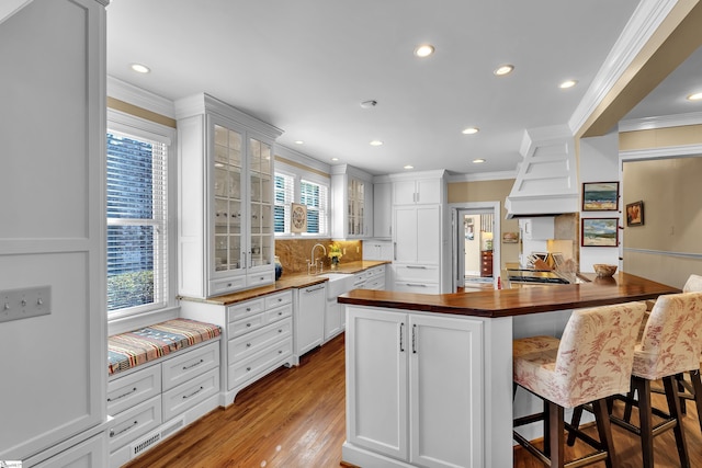 12 Cothran St, Greenville, SC 29605 - kitchen with white cabinetry, white dishwasher, a breakfast bar area, and crown molding