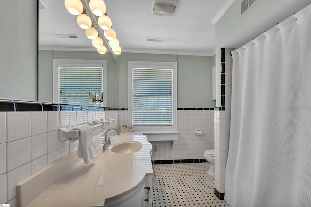 12 Cothran St, Greenville, SC 29605 - bathroom featuring vanity, crown molding, tile walls, and toilet