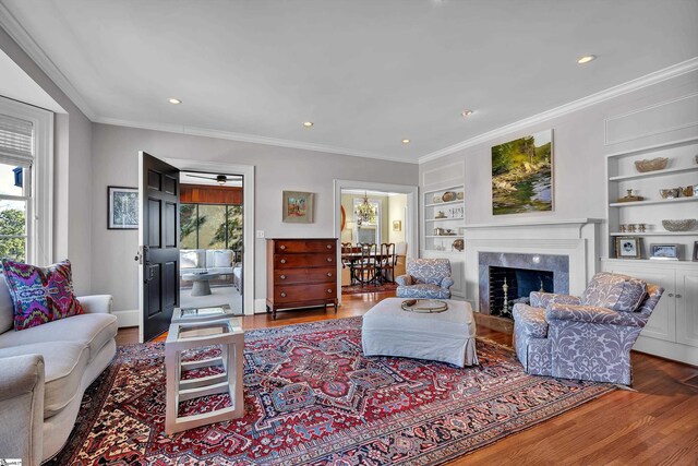 12 Cothran St, Greenville, SC 29605 - living room featuring ornamental molding, a healthy amount of sunlight, wood-type flooring, and built in features