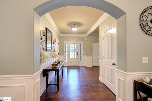 entryway with crown molding and dark wood-type flooring