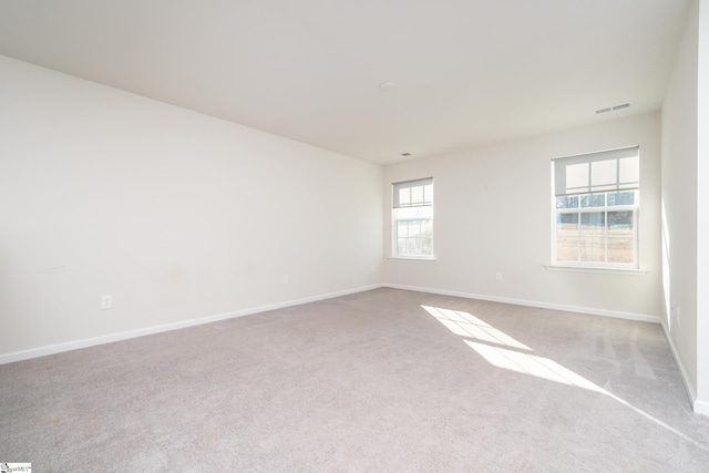 unfurnished room featuring light colored carpet