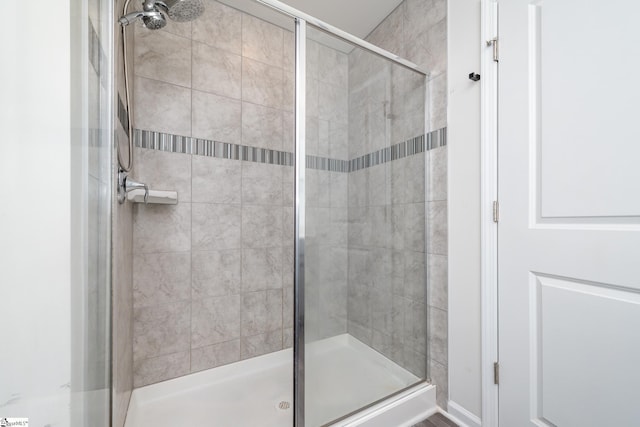 bathroom with a shower with door