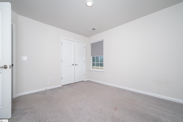 unfurnished room featuring light colored carpet