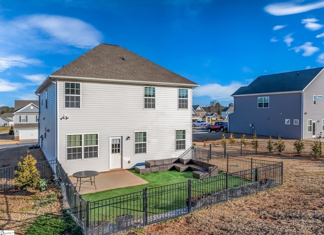 rear view of house featuring a yard and a patio