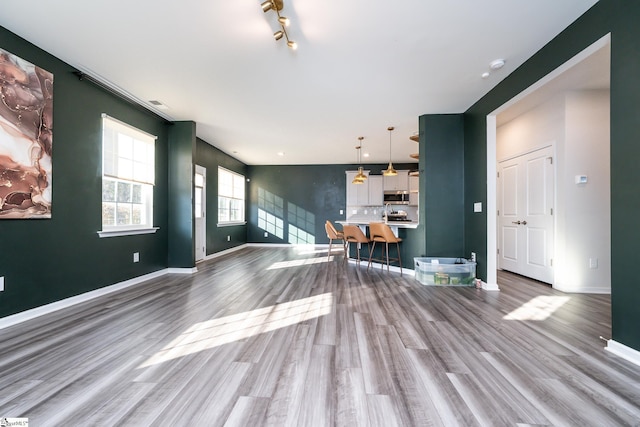 unfurnished living room featuring hardwood / wood-style floors