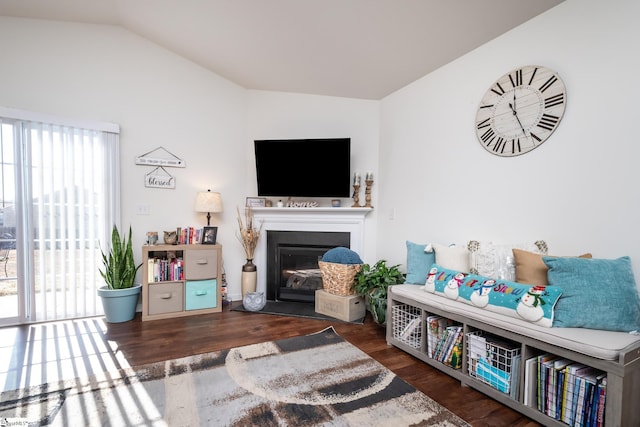 living room featuring dark hardwood / wood-style floors and vaulted ceiling