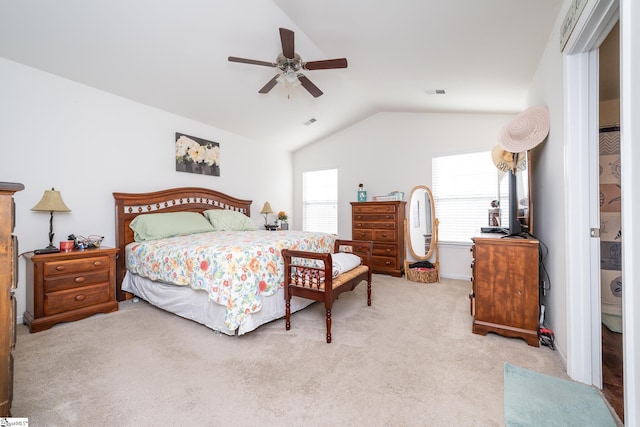 bedroom featuring light carpet, vaulted ceiling, and ceiling fan