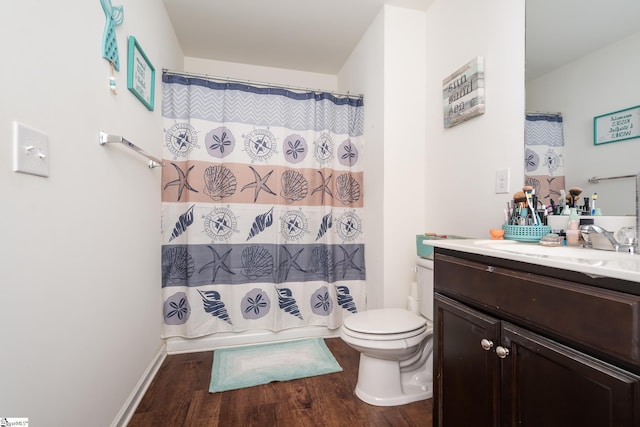 bathroom featuring vanity, hardwood / wood-style floors, a shower with curtain, and toilet