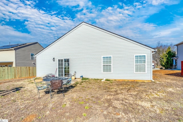 rear view of property featuring a lawn