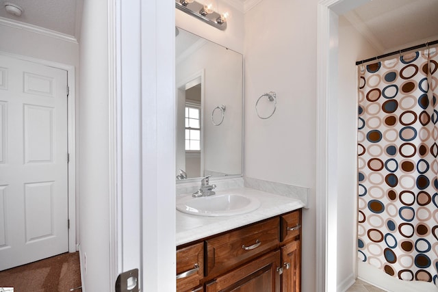 bathroom featuring crown molding, vanity, and walk in shower