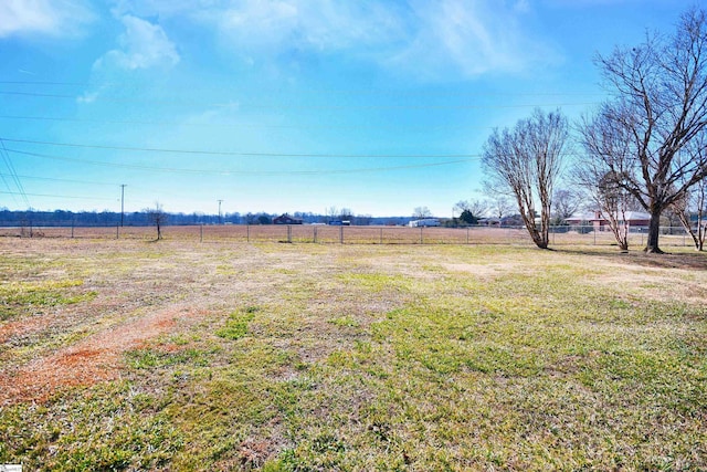 view of yard with a rural view and fence