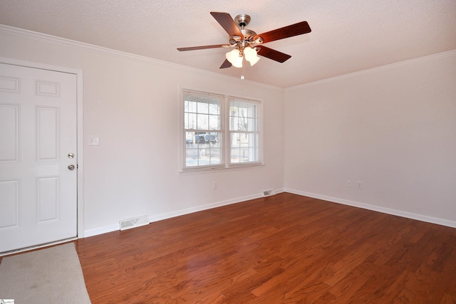 empty room with dark wood-type flooring, ceiling fan, crown molding, and a textured ceiling