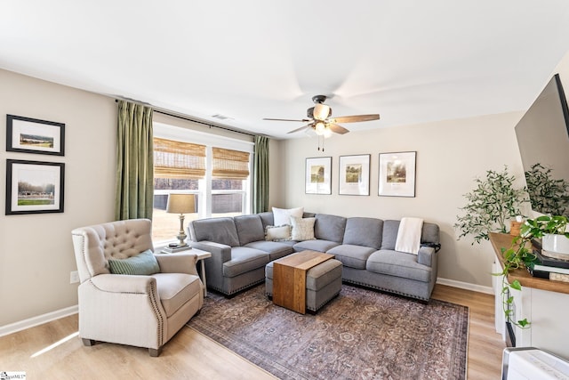 living room featuring light hardwood / wood-style floors and ceiling fan