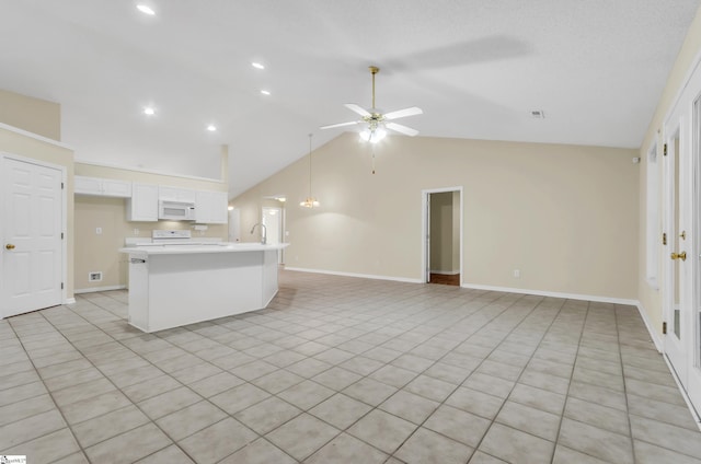 kitchen featuring light tile patterned flooring, a kitchen island, lofted ceiling, white cabinets, and ceiling fan