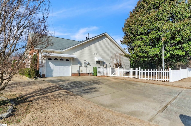 view of side of home featuring a garage