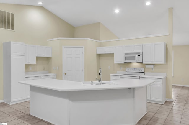 kitchen featuring a kitchen island with sink, sink, white cabinets, and white appliances