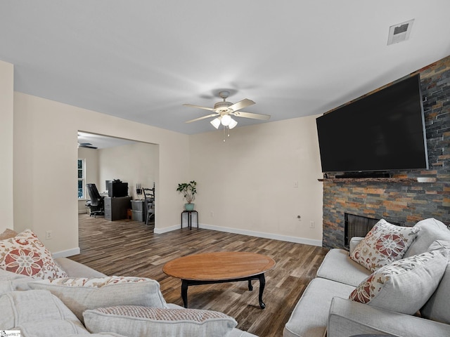 living room with hardwood / wood-style floors, a fireplace, and ceiling fan