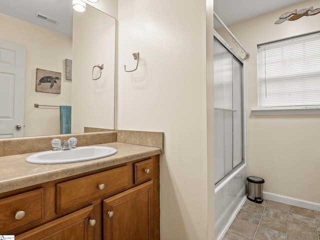 bathroom with enclosed tub / shower combo and vanity