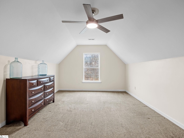 additional living space with lofted ceiling, light carpet, and ceiling fan