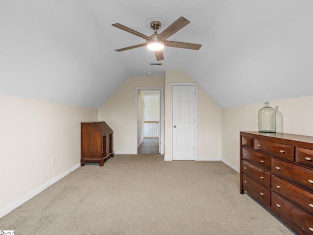 additional living space with vaulted ceiling, light carpet, and ceiling fan