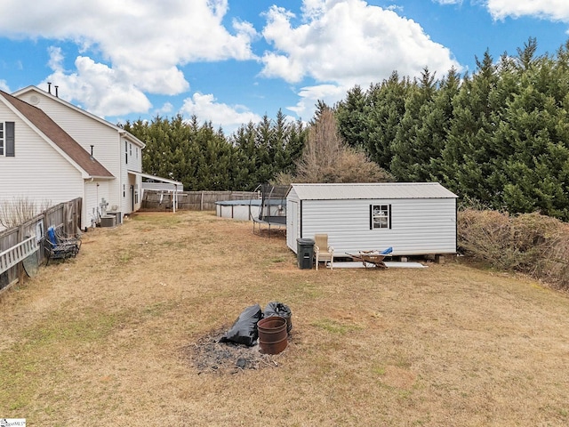 view of yard with an outdoor structure, a swimming pool, and central air condition unit