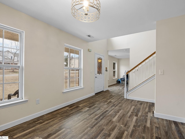 entrance foyer with plenty of natural light and dark hardwood / wood-style flooring