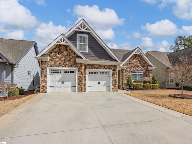 craftsman inspired home featuring a garage and concrete driveway