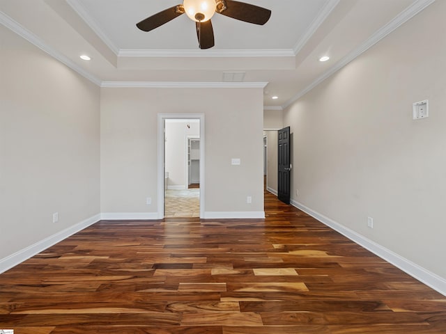 unfurnished bedroom with recessed lighting, a raised ceiling, baseboards, and wood finished floors