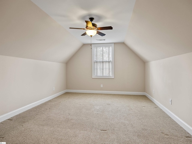 bonus room featuring lofted ceiling, visible vents, a ceiling fan, carpet flooring, and baseboards