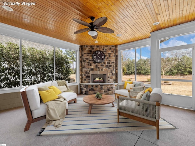 sunroom / solarium with wood ceiling, a brick fireplace, and plenty of natural light